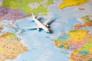 A plane parked on a world map, representing global travel and exploration