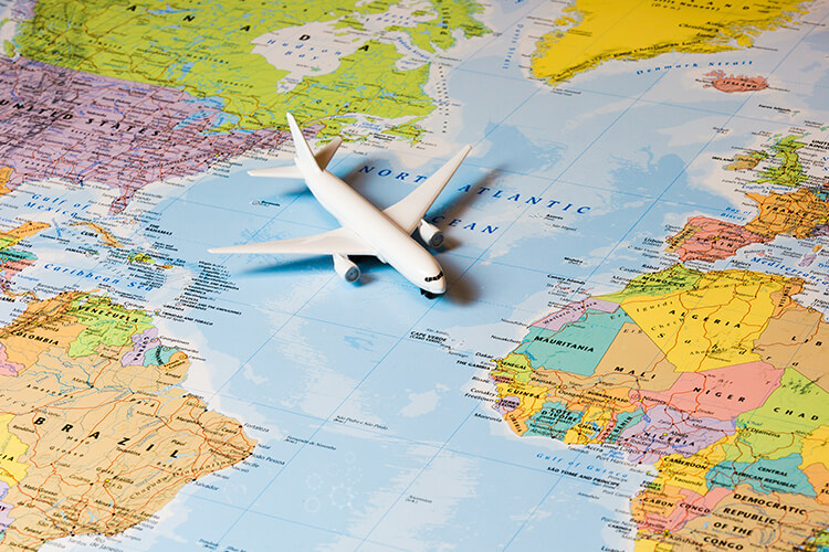 A plane parked on a world map, representing global travel and exploration