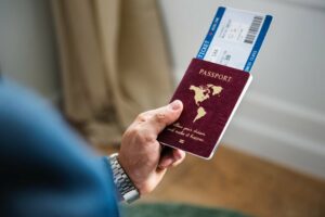 A person holding a passport and boarding pass, ready for travel