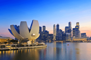 A city skyline with a towering building in the foreground, showcasing the urban landscape and architectural grandeur