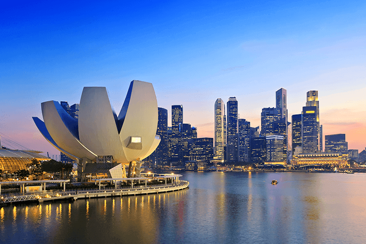 A city skyline with a towering building in the foreground, showcasing the urban landscape and architectural grandeur