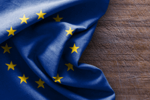 European Union flag on wooden background. Symbol of unity and cooperation among European countries