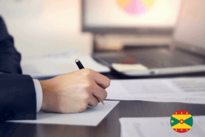 A professional man in a suit writing on paper with a pen, focused and engaged in his task