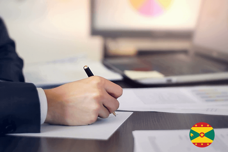 A professional man in a suit writing on paper with a pen, focused and engaged in his task