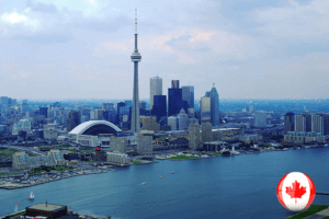 City skyline with Canadian flag flying high. A patriotic symbol against a backdrop of urban architecture