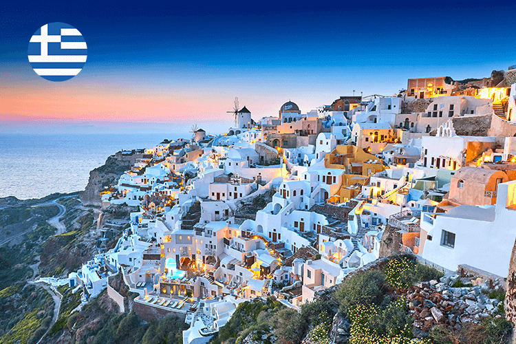 A stunning sunset casts a warm glow over Santorini, a Greek island