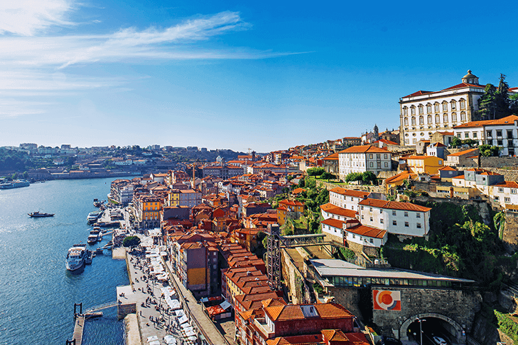 A bustling cityscape with towering buildings and a meandering river flowing through it