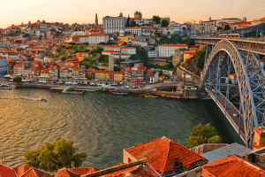 A picturesque cityscape featuring a bridge spanning over a river, showcasing the beauty of urban architecture and natural waterways