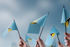 Hands holding flags of the Saint Lucia, symbolizing national pride and unity